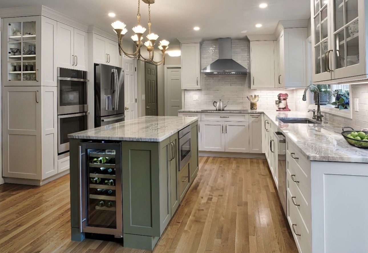 Avon, CT kitchen remodel detail — marble island with cutting board, a bay window over the sink looking into the woods, and brass floral pendant lighting by Central Connecticut Building and Remodeling.